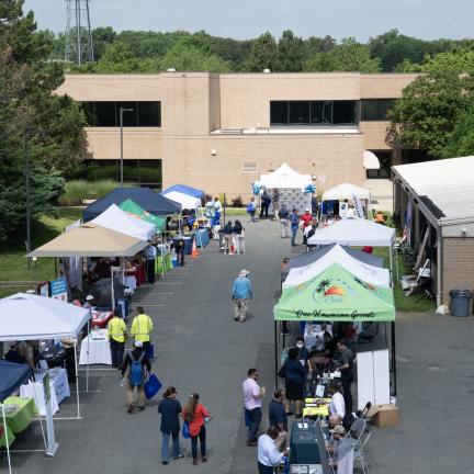 Photo: an overhead view of people socializing at tables at a vendor expo