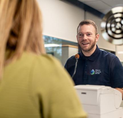 Photo: a customer service representative at a window