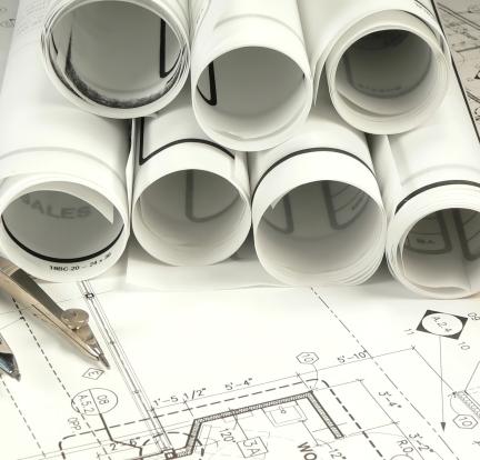 Photo: rolled up engineering plans on a table