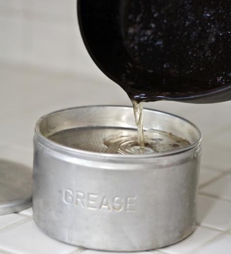 Photo: pouring grease into an aluminum can